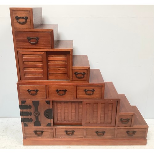 578 - A 20th century Japanese Tansu stair storage system comprising various drawers with black metal handl... 