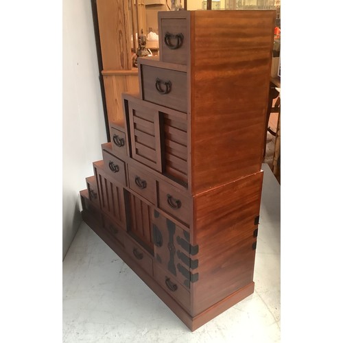 578 - A 20th century Japanese Tansu stair storage system comprising various drawers with black metal handl... 