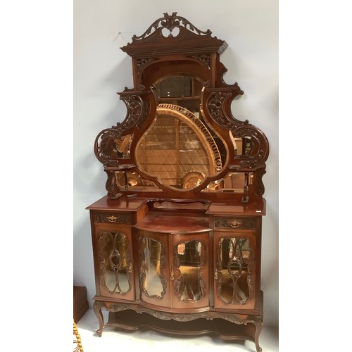 576 - A Victorian stained walnut Roccoco revival tall mirror-back glazed sideboard, with central bow-front... 