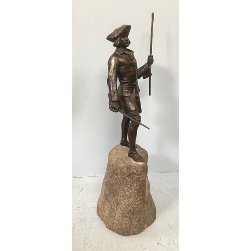 518 - A bronze figure of an 18th century gent in tricorn hat and frock coat holding a sword in one hand an... 