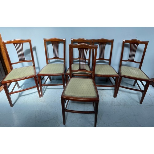 585 - A set of six Edwardian mahogany standard chairs, with inlaid backs and pale green upholstered drop i... 