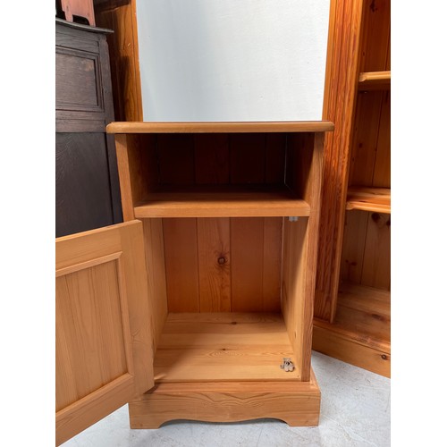 591 - A modern pine bookcase with two adjustable shelves, fluted sides, 120cm wide, together with a pair o... 