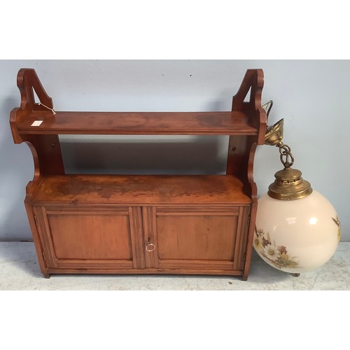 581 - A small stained mahogany wall hanging cupboard with shelf above, 60cm wide, together with a white gl... 