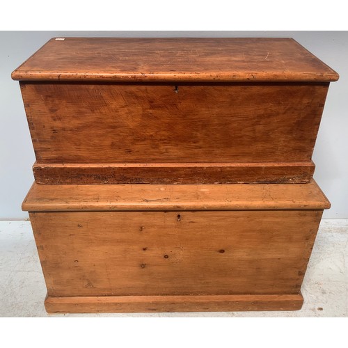 563 - Two various pine chests with twin-metal handles, the larger opening to reveal two small side drawers... 