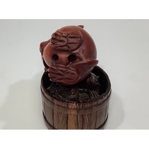 64 - A boxwood netsuke carved rabbit eating a leaf, signature to base, together with an okimono carved as... 