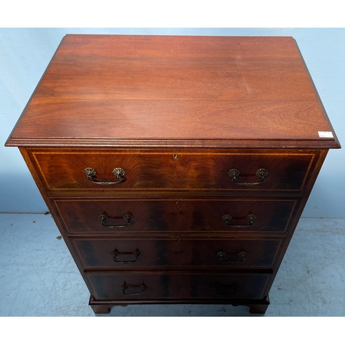 599 - An Edwardian mahogany cross-banded chest of four long graduated drawers with brass handles, raised o... 