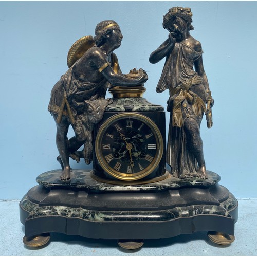 456 - A bronze figural mantel clock modelled with two musicians, the man holding a birds nest with two bir... 