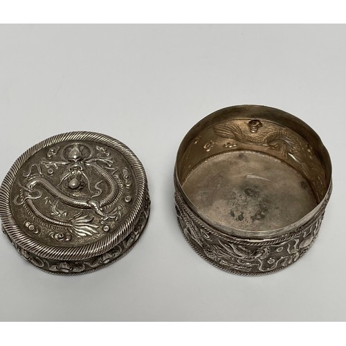 89 - A Chinese silver pill/spice pot and cover, of circular form, the sides and lid with repoussé decorat... 