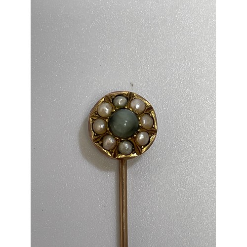 231 - A yellow metal (tests as 9ct gold) tie pin with circular top set with seed pearls and a blue/green s... 