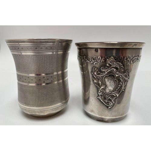 106 - A white metal beaker (tests as 800) with band of foliage and engraved cartouche, 8cm high, together ... 