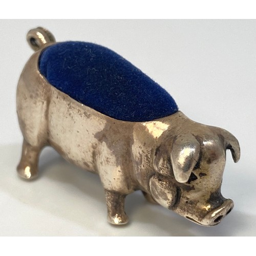 84 - A silver pin cushion modelled as a pig with curled tail, stamped ‘925’, approximately 4cm long