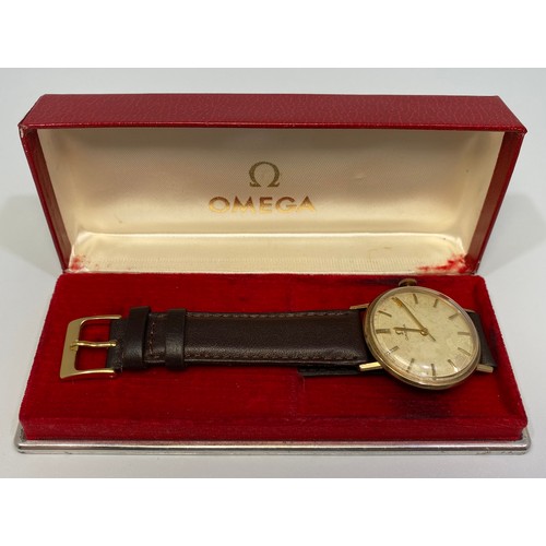 128 - A gents 9ct gold cased Omega wristwatch, the silvered dial with applied gold batons denoting hours, ... 