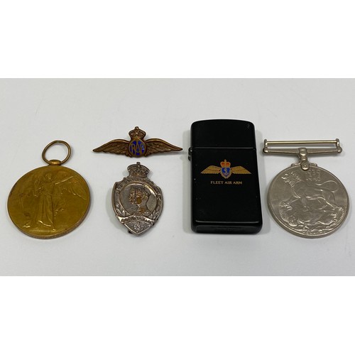 390 - A WWI Victory Medal awarded to DVR H Blakeman, together with a WWII Service Medal, an RAF cap badge,... 