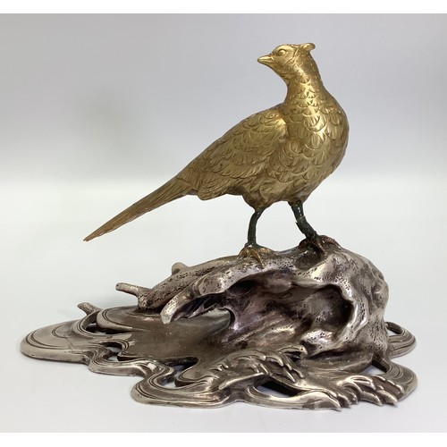 520 - A Chinese gilt figure of a pheasant looking over its right wing, perched on a silvered naturalistic ... 