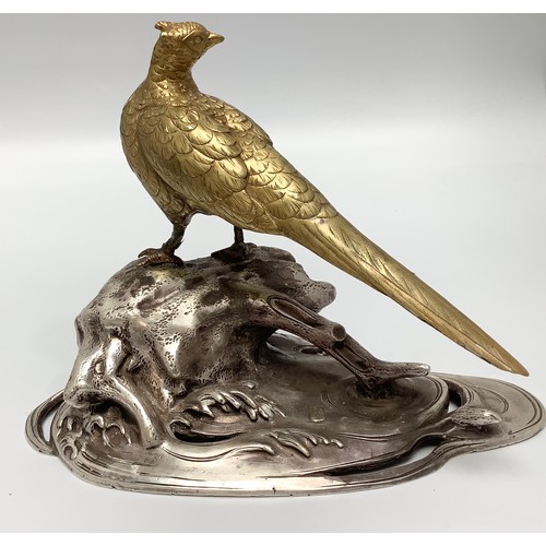 520 - A Chinese gilt figure of a pheasant looking over its right wing, perched on a silvered naturalistic ... 