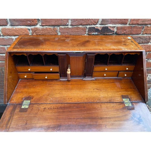 611 - An inlaid walnut bureau with fall front opening to reveal compartmented interior and secret compartm... 