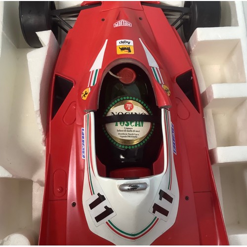 577 - A Toschi promotional model of a Ferrari Formula 1 car with a bottle of Nocino liqueur, 70cm long, bo... 