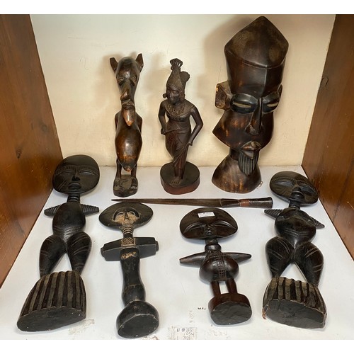 387 - A quantity of ethnic carved figures including African fertility statues, a steel bladed knife and a ... 