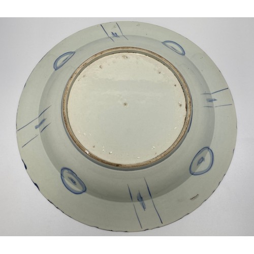 73 - A large Chinese porcelain 'Kraak ware' dish, painted in underglaze blue and typically radially compa... 