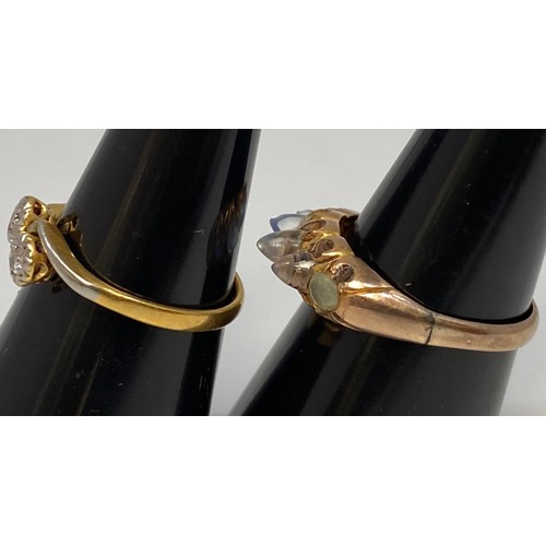 221 - An 18ct white and yellow gold crossover ring, with two small illusion set diamonds, gross weight app... 