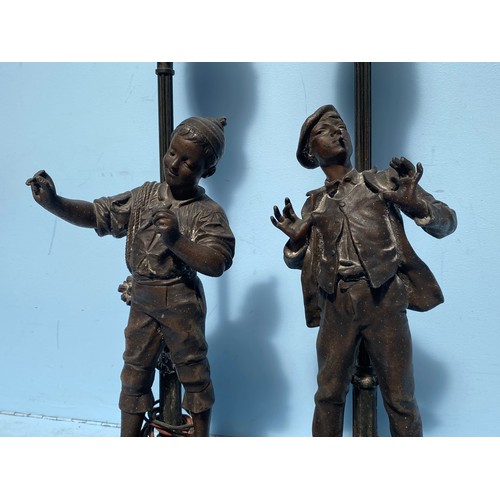 540 - A pair of bronzed spelter figural lamps after Eutrope Bouret, modelled as lamplighters by street lam... 