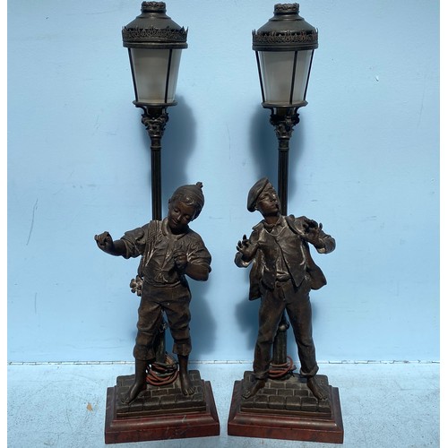 540 - A pair of bronzed spelter figural lamps after Eutrope Bouret, modelled as lamplighters by street lam... 