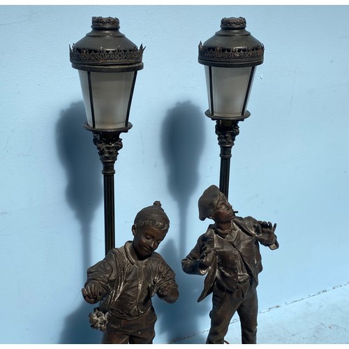 540 - A pair of bronzed spelter figural lamps after Eutrope Bouret, modelled as lamplighters by street lam... 