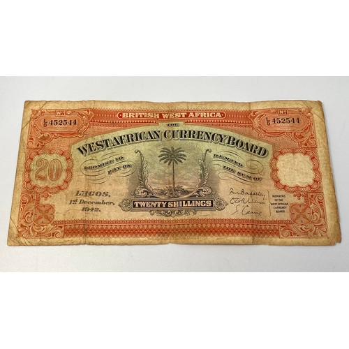 395 - A West African Board 20 shilling note ‘Lagos 1st December 1942’ serial no. L5/452544, central palm t... 