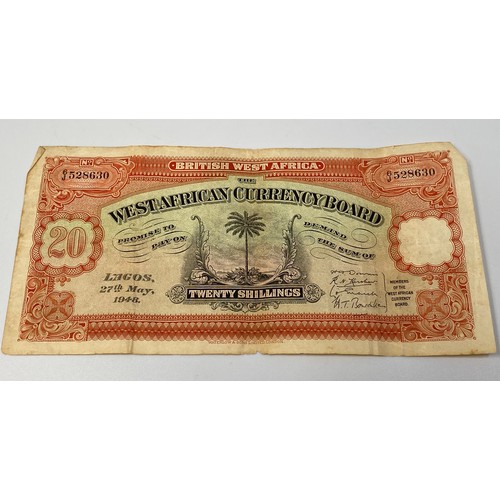 396 - A West African Board 20 shilling note ‘Lagos 27th May 1948’ serial no. 6J/528630, central palm tree ... 