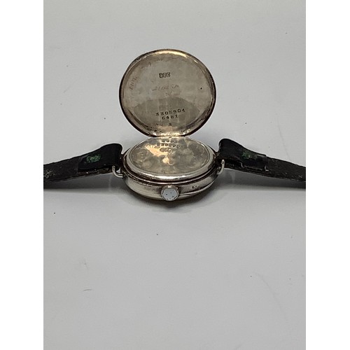 156 - A silver cased trench watch, the white enamel dial with Arabic numerals denoting hours and subsidiar... 