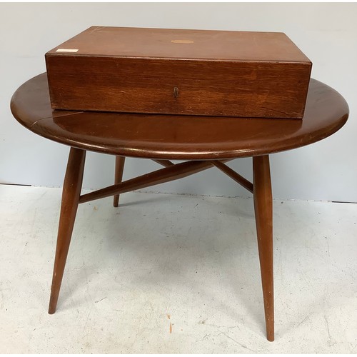 610 - A small Ercol occasional low table with single drop leaf, 61cm diameter, together with a silver-plat... 