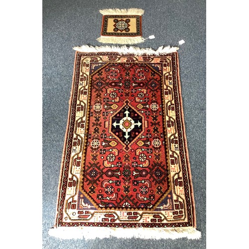 470 - Four various hand knotted rugs including a red, cream and blue rug with geometric design and a hall ... 