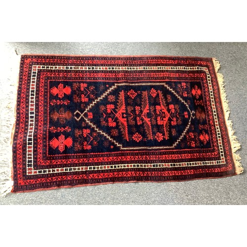 470 - Four various hand knotted rugs including a red, cream and blue rug with geometric design and a hall ... 