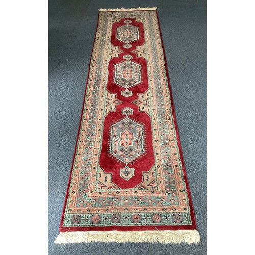 470 - Four various hand knotted rugs including a red, cream and blue rug with geometric design and a hall ... 