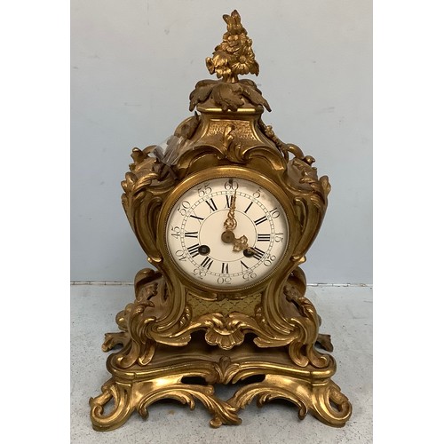 459 - A French gilt bronze mantel clock with floral cast finial, scrolled sides, white enamel dial with Ro... 