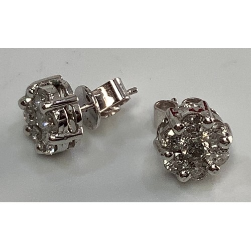 267 - A pair of 14ct white gold and diamond cluster stud earrings, each set with seven round brilliant cut... 