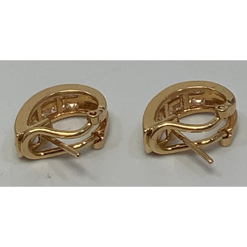 260 - A pair of 18ct yellow gold curved earrings, each channel set with 18 princess cut diamonds, estimate... 