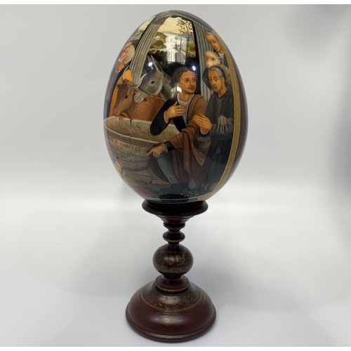 337 - A St Petersburg hand-painted and laquered papier-mache egg depicting the Adoration of the Magi, sign... 