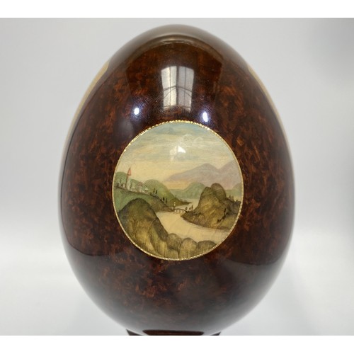 337 - A St Petersburg hand-painted and laquered papier-mache egg depicting the Adoration of the Magi, sign... 