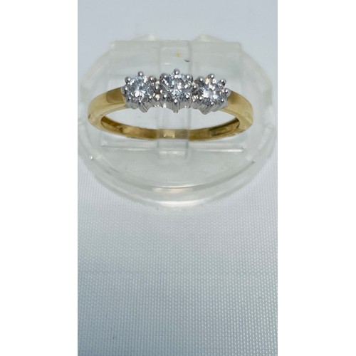 187 - An 18ct yellow gold three stone diamond ring, set with three round brilliant cut diamonds in a claw ... 