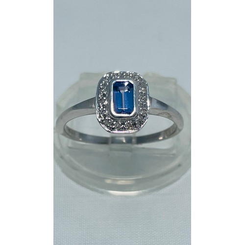 192 - A 9ct white gold dress ring, set with an emerald cut tanzanite to the centre, with small diamonds su... 