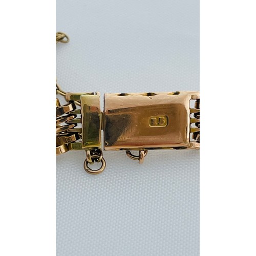 196 - A 15ct yellow gold gate bracelet, with safety chain, weighing 11.8 grams.