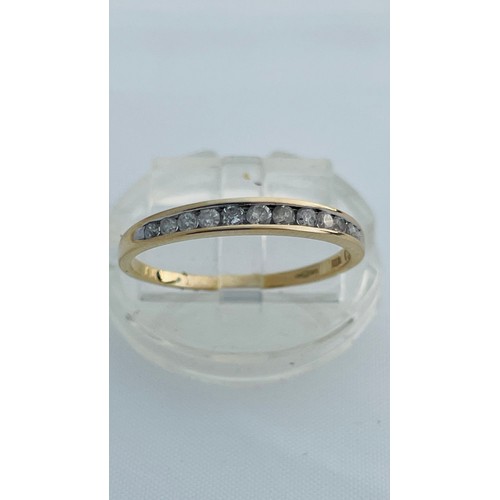 197 - A 9ct yellow gold eternity ring, set with 12 x small round diamonds in a channel setting, total diam... 