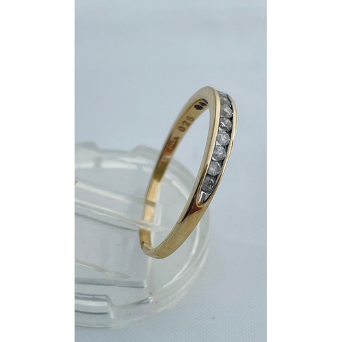 197 - A 9ct yellow gold eternity ring, set with 12 x small round diamonds in a channel setting, total diam... 