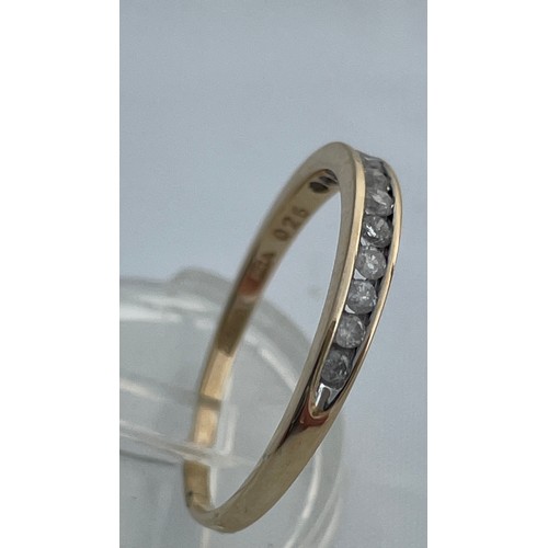 197 - A 9ct yellow gold eternity ring, set with 12 x small round diamonds in a channel setting, total diam... 