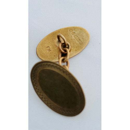 199 - A pair of 9ct gold oval shaped cufflinks with chains, weighing 5.2 grams.