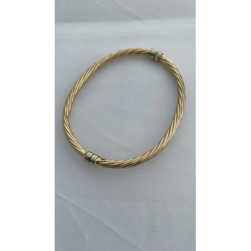 200 - Addendum 14ct not 9ct gold, a hollow hinged bangle, in a rope twist design with safety catch, weighi... 