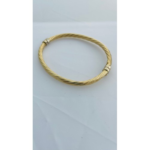 200 - Addendum 14ct not 9ct gold, a hollow hinged bangle, in a rope twist design with safety catch, weighi... 