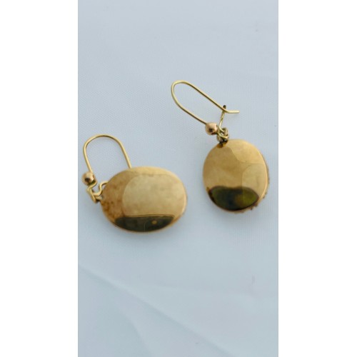 201 - A pair of 15ct gold oval shaped drop earrings, set with seed pearls and blue enamel, on 9ct gold wir... 