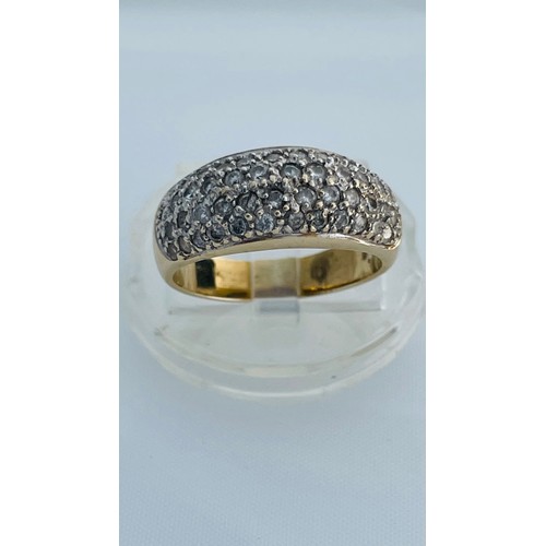 202 - A 9ct yellow gold dress ring, pave set with small round diamonds, estimated total weight of diamonds... 